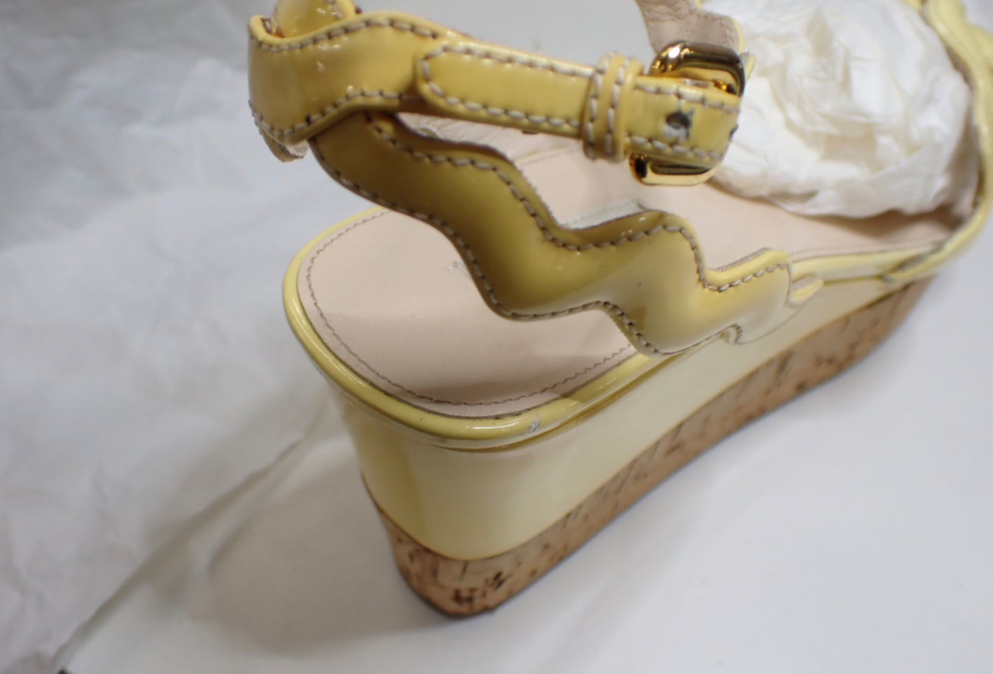 Prada Patent Leather Wavy Strap Wedge Sandals in a light butter yellow hue.
