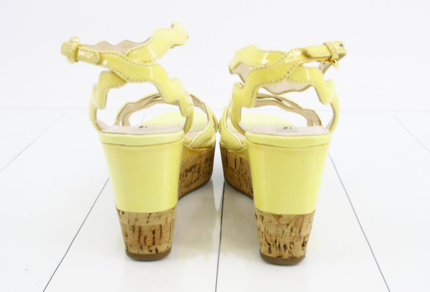 Prada Patent Leather Wavy Strap Wedge Sandals in a light butter yellow hue.