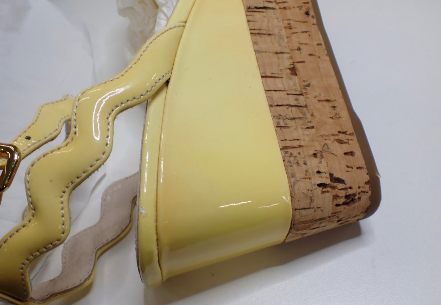 Prada Patent Leather Wavy Strap Wedge Sandals in a light butter yellow hue.